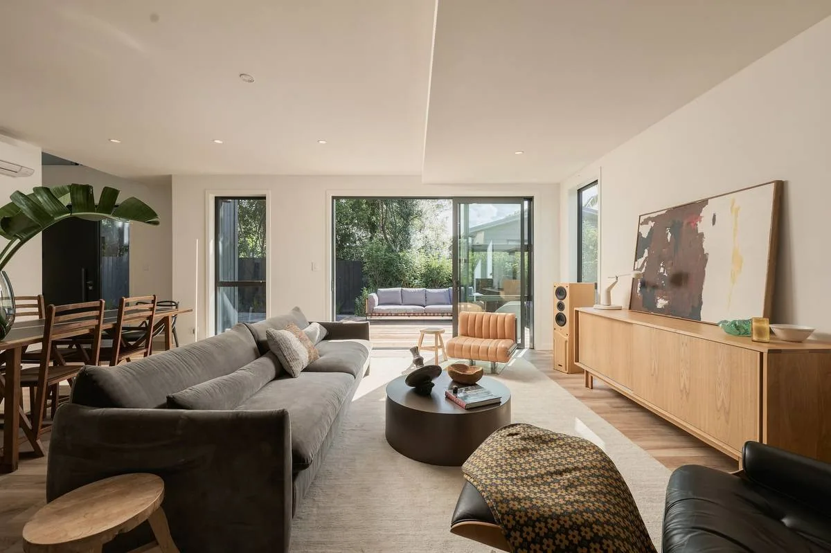 Living room in the Editorial style: warm, directional light with retained shadow